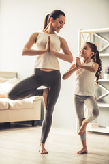 Mom and daughter doing yoga
