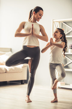 Mom And Daughter Doing Yoga