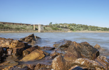 Fototapeta na wymiar Dam of Cornalvo Reservoir from shore, Spain