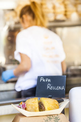 Details of a food truck with a defocused woman cooking