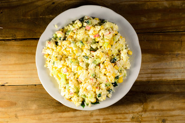 Salad with crab sticks, corn, cucumber, and eggs