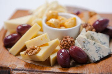 various types of cheese on a wooden board