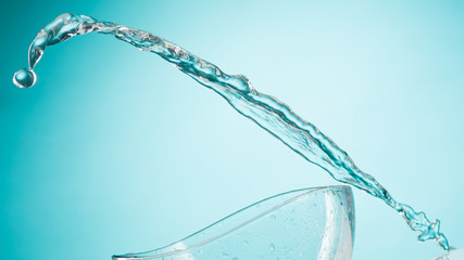 The water splashing to glass bowl on white background