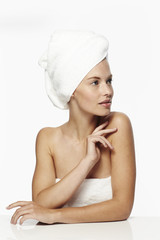 Beautiful woman wearing white towel, looking away