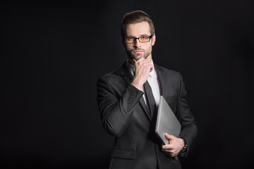 Businessman holding laptop