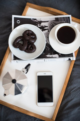 Fototapeta premium Coffee and breakfast in bed, smartphone and magazine