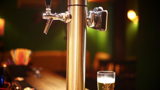 Vertical panoramic video of a beer glass on a counter in a pub or restaurant, next to a beer tap.