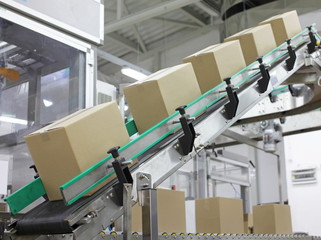 Automation - Cardboard boxes on conveyor belt in factory