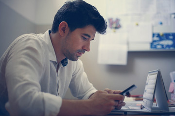 Fototapeta premium Businessman using smart phone in the office.