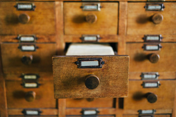 Open old style wooden drawer with index cards
