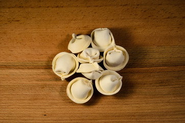Heap of the frozen dumplings on wooden table