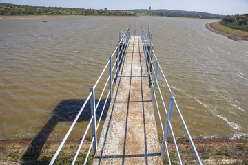 Modern footbridge attached to Dam of Cornalvo Reservoir. This monument is still in use nowadays, Extremadura, Spain