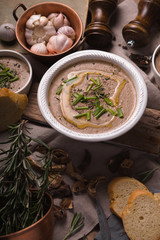 Mushroom cream soup on the rustic background vertical