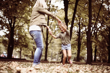 Fototapeta premium Mother and daughter playing in the park.