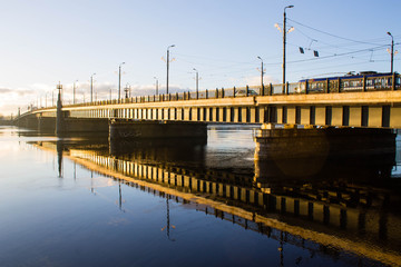 Obraz premium Sunset light over bridge and river in Riga, Latvia