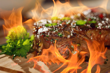 grilled steak with flames