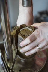 Civil engineer preparing a soil sample for a laboratory test in order to determine shear strength. Soil being tested for mechanical characteristics before construction works.
