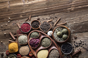 various dry spices on a wooden table