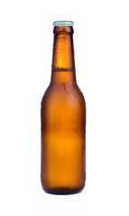 Bottle of beer with drops isolated on white background
