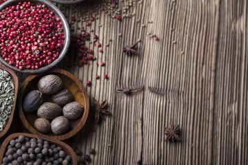 various dry spices on a wooden table
