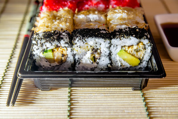 a plate of sushi pieces standing on a bamboo napkin 