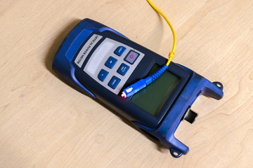 Optical power meter with yellow patchcords is on the table
