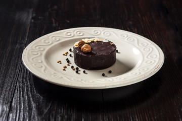 Beautiful decorated chocolate cake with golden nuts