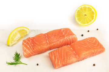 Two slices of salmon on white background with copyspace