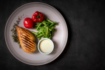 Marinated grilled healthy chicken breast served with vegetables