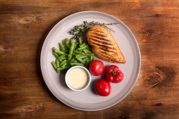 Marinated grilled healthy chicken breast served with vegetables