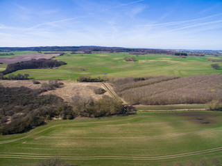 Fototapeta na wymiar Aerial view of a green rural area agricultural fields under blue sky in germany