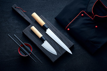 Asian kitchen chef accessories on black stone table - obrazy, fototapety, plakaty