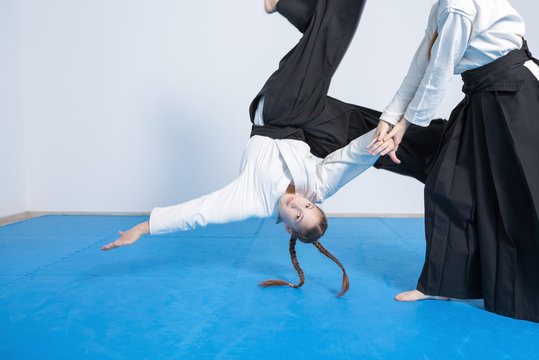 Two girls in black hakama on Aikido training
