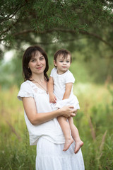 Fototapeta premium mom hugs daughter walk outside, concept parenthood