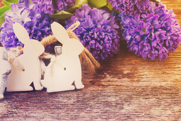 withe easter rabbits and hyacinth flowers on table, retro toned