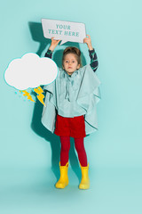 Little girl posing in fashion style wearing autumn clothing.