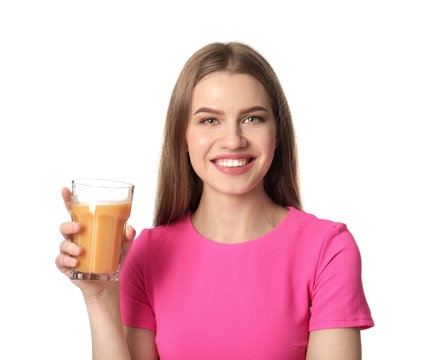 Beautiful young woman with glass of fresh juice on light background