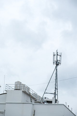 Antenna broadcasting tower on the rooftop of apartment
