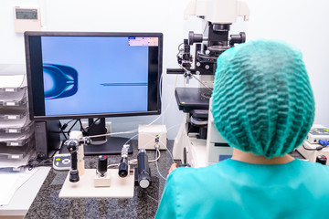 Embryologist adding sperm to egg in laboratory of reproductive clinic. Selective focus