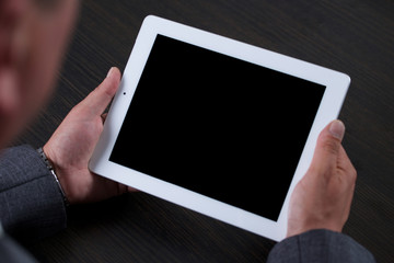 Close up of man using tablet. Black screen.