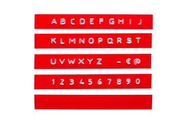 embossed alphabet on red plastic tape, isolated on white