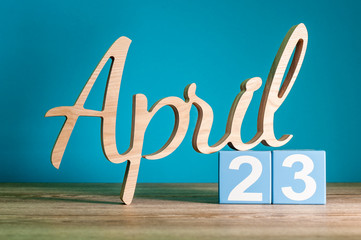 April 23rd. Day 23 of month, daily calendar on desk with blue background. Spring time concept