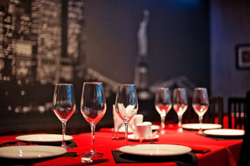 Glasses in a black and red restaurant. Serving tables with cafe