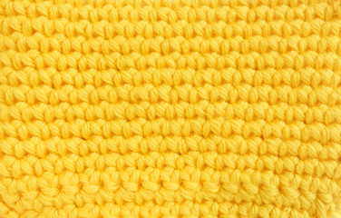 Crochet pattern, a close-up of a simple yellow crochet pattern for background