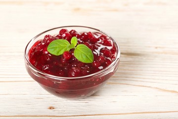 cranberries jam on a wooden background