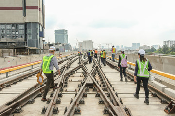 Fototapeta premium Engineer walk on track or railway on viaduct of sky train for inspect trackwork