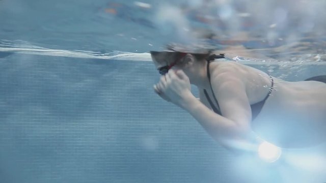 Pregnant girl beautiful swims. Underwater photography.