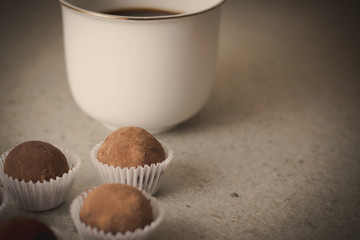 HOmemade cocoa truffles with cup of coffee