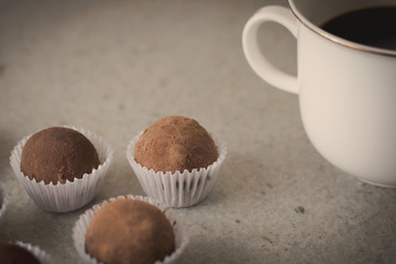 HOmemade cocoa truffles with cup of coffee