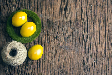 yellow eggs in grass circle with rope roll